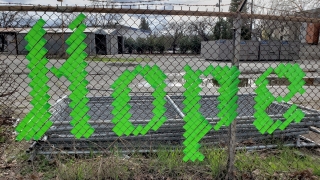 Hope spelled out on fence in lime green